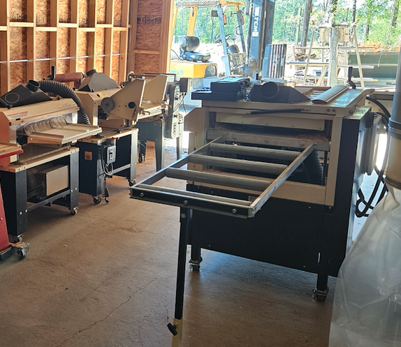 Photo shows 4 of Ricky's NINE Woodmaster including his newest machine, the 4-Head Woodmaster 4000